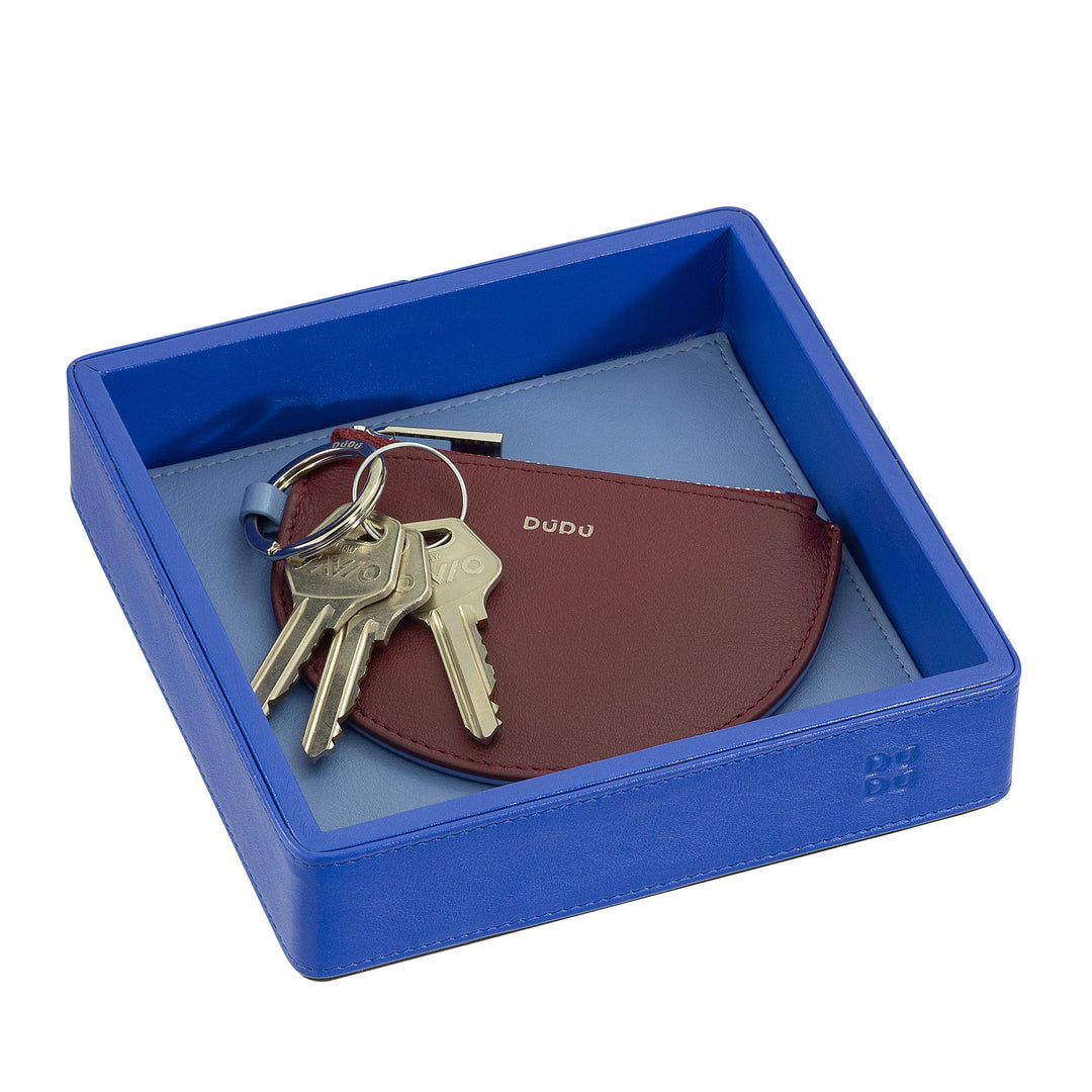 Leather key holder with keys in a blue tray