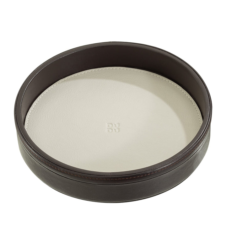 Round leather catchall tray with a brown exterior and white interior