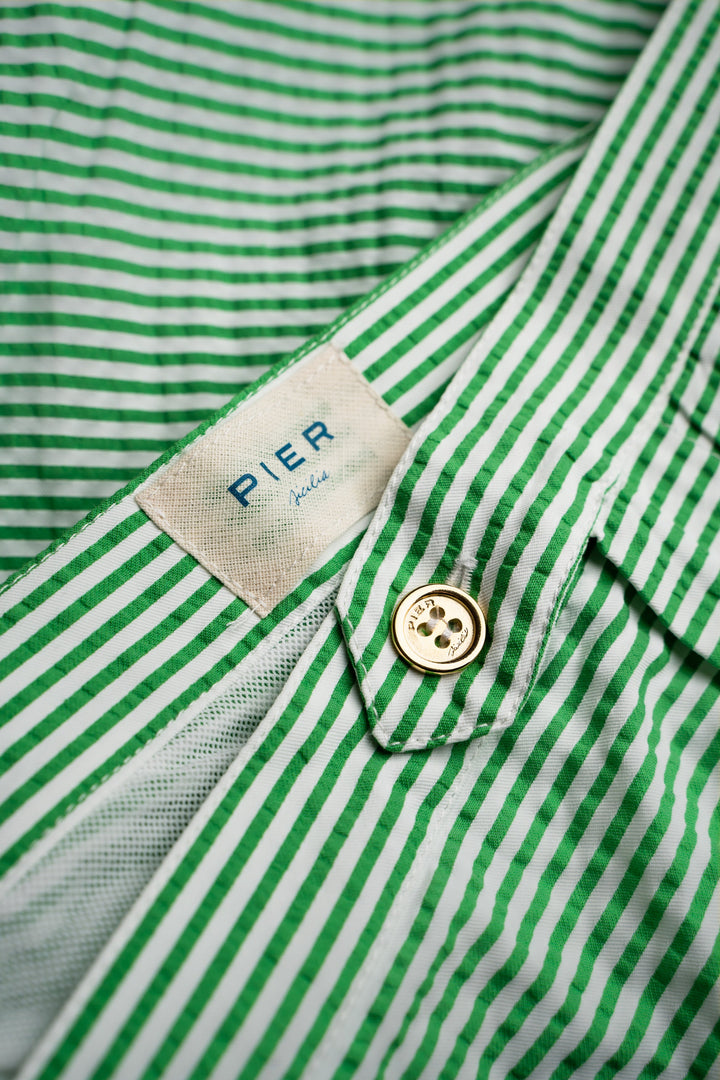 Green and white striped shirt with a visible label and button detail