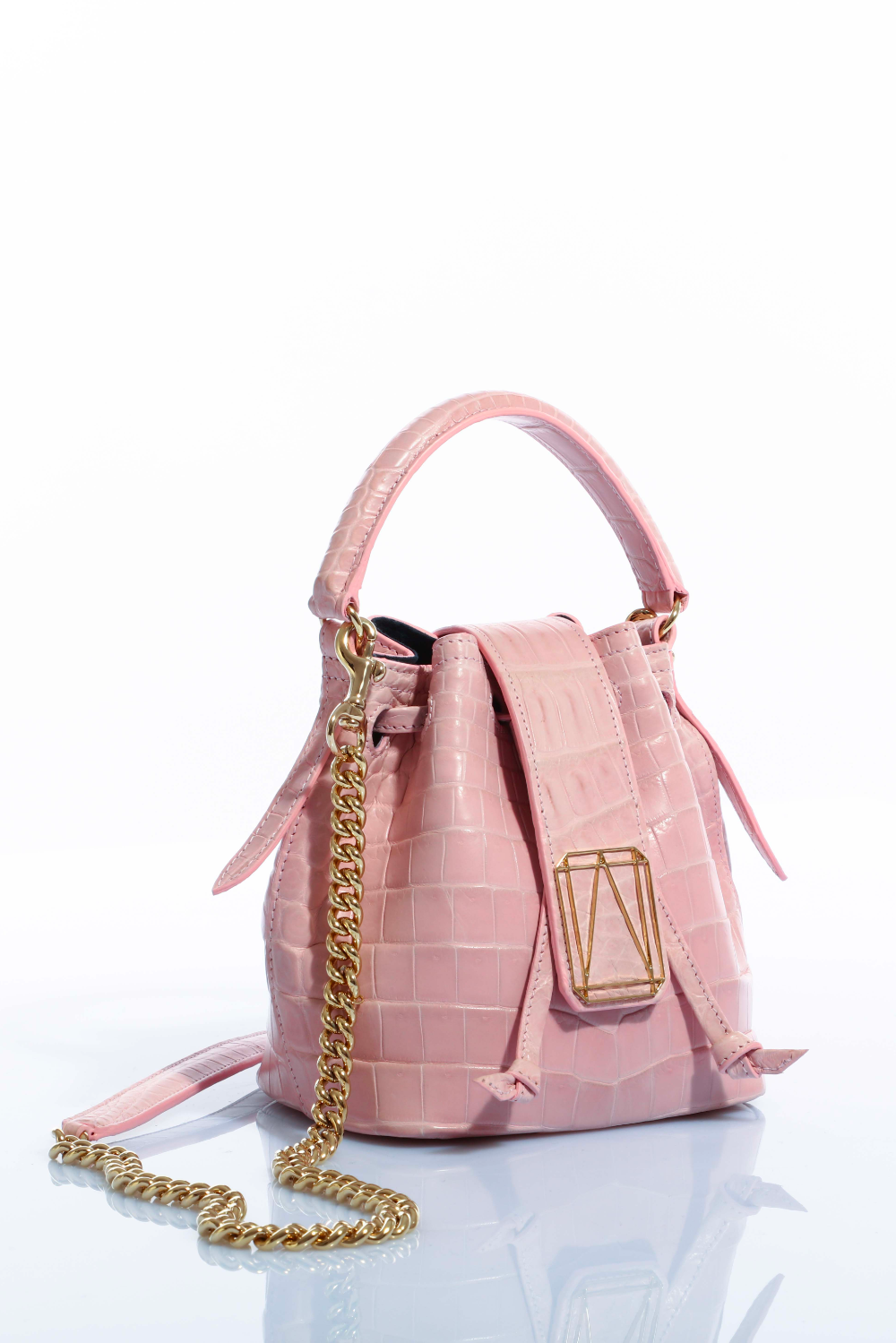 Pink leather handbag with gold chain strap on white background