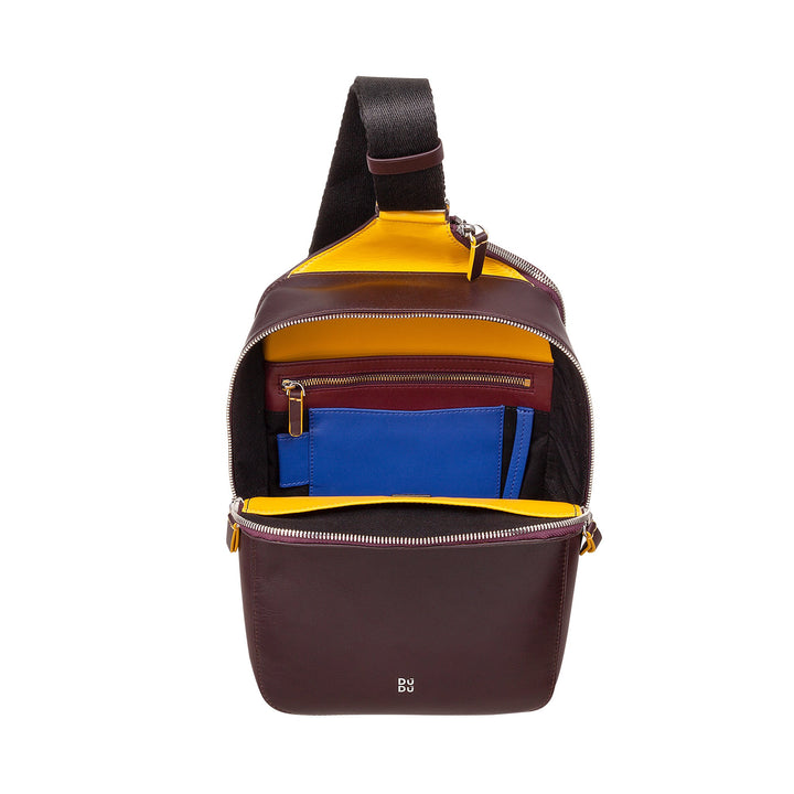 Compact maroon leather backpack with bright yellow interior and segmented compartments displaying blue and red accessory pouches
