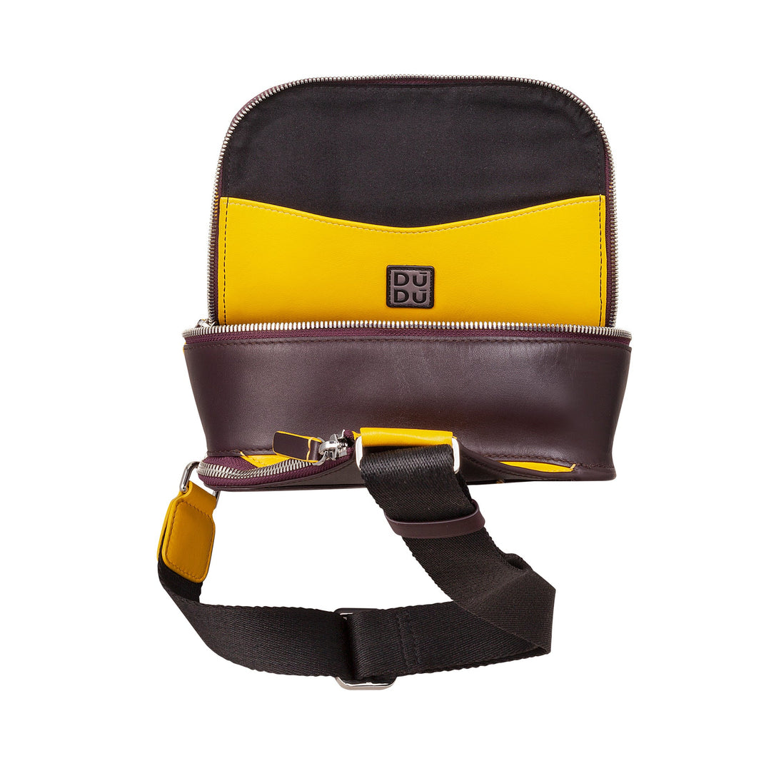 Two-tone leather crossbody bag with brown, yellow, and black accents, open to show its compartments