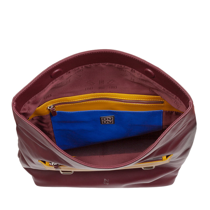 Open maroon leather handbag with colorful interior pockets