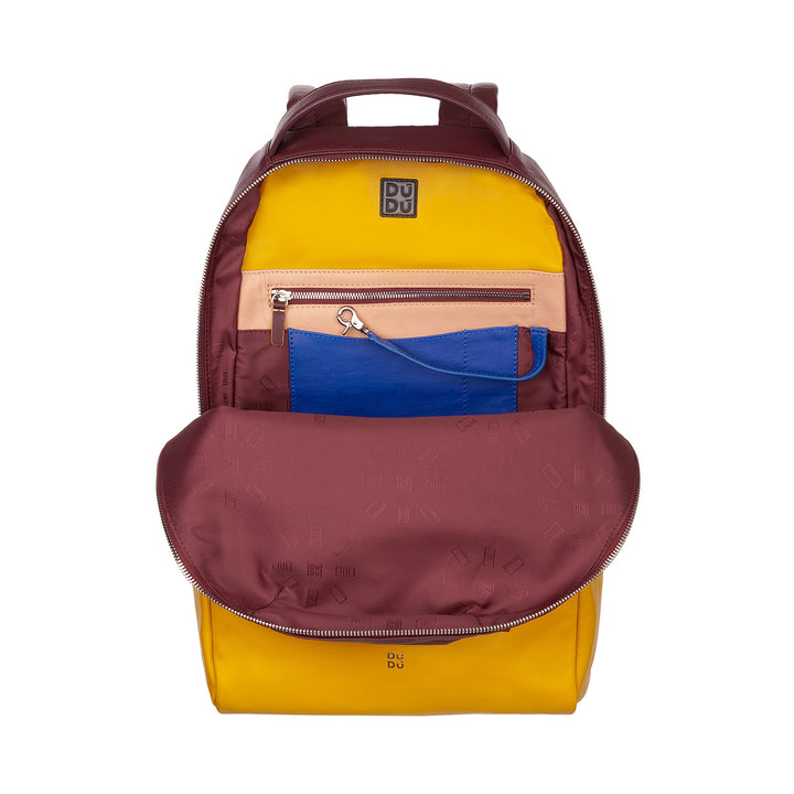 Colorful backpack with yellow, maroon, and blue compartments, featuring a top handle and multiple zippers