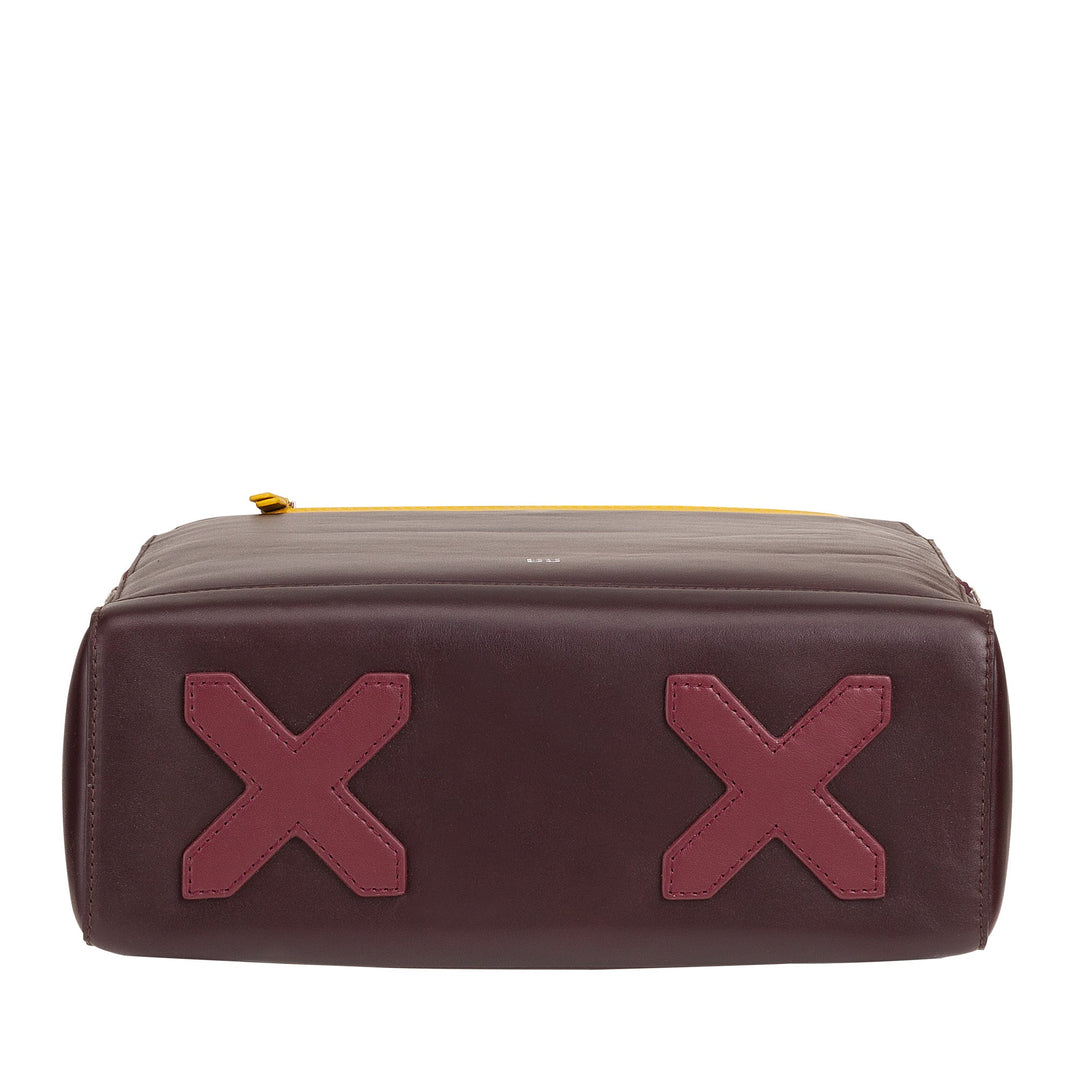 Brown leather bag with pink X-shaped details on the bottom, yellow zipper on top