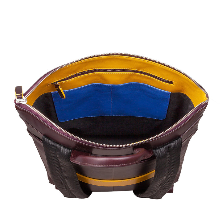 Luxury leather tote bag with open top view showing yellow, blue, and black interior pockets