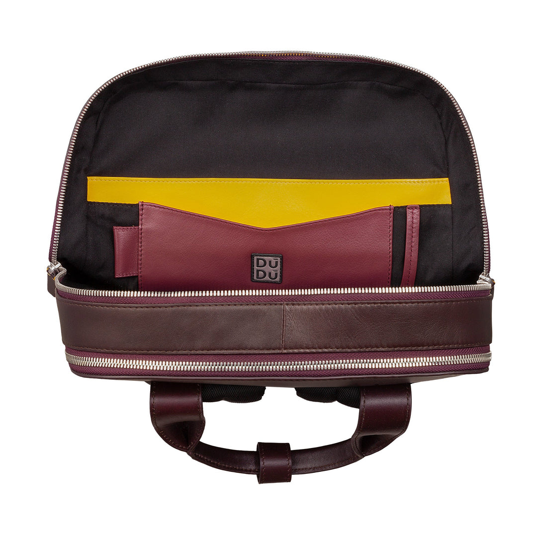 Open brown leather backpack with visible compartments and yellow and maroon interior pockets