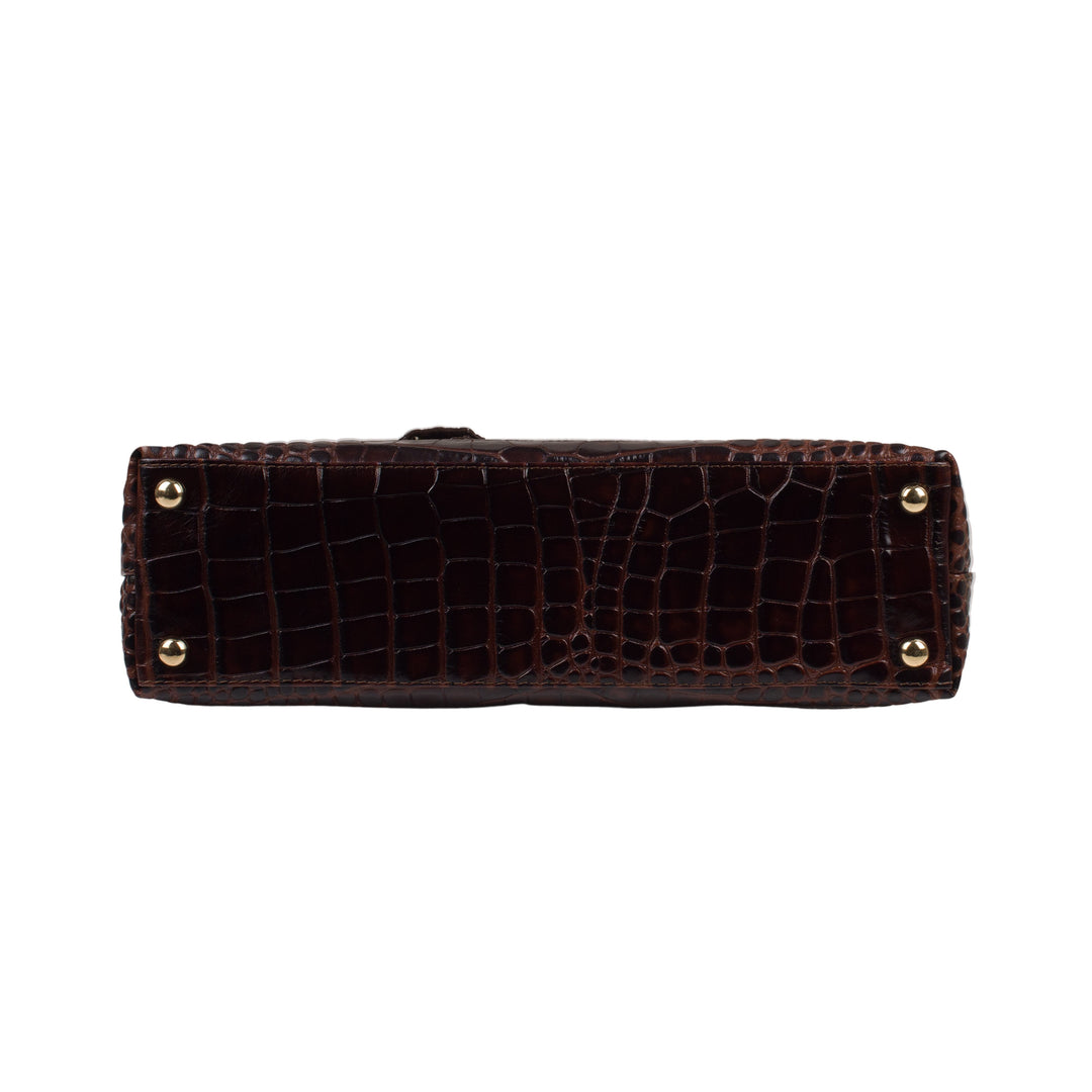 Bottom view of a dark brown crocodile-embossed handbag with gold-tone hardware