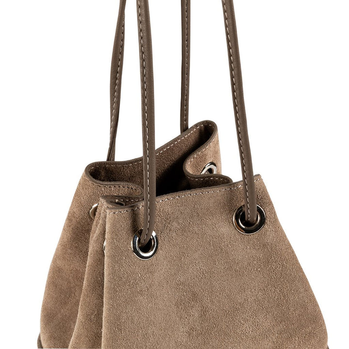 Tan suede drawstring handbag with leather straps and metal grommets