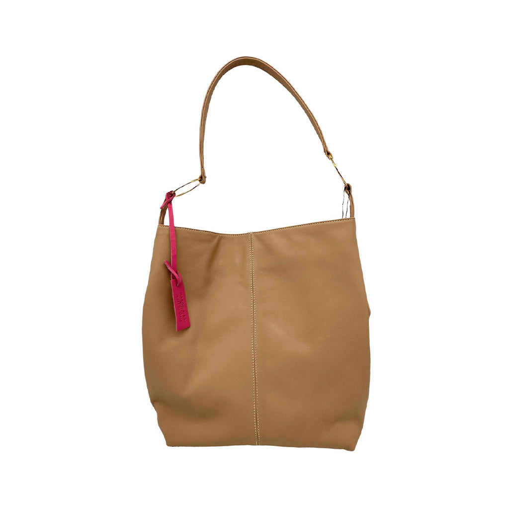 Tan leather tote bag with single shoulder strap and red tag