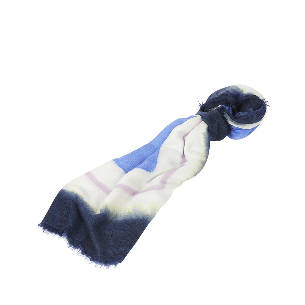 Blue and white ombre scarf with frayed edges on a white background