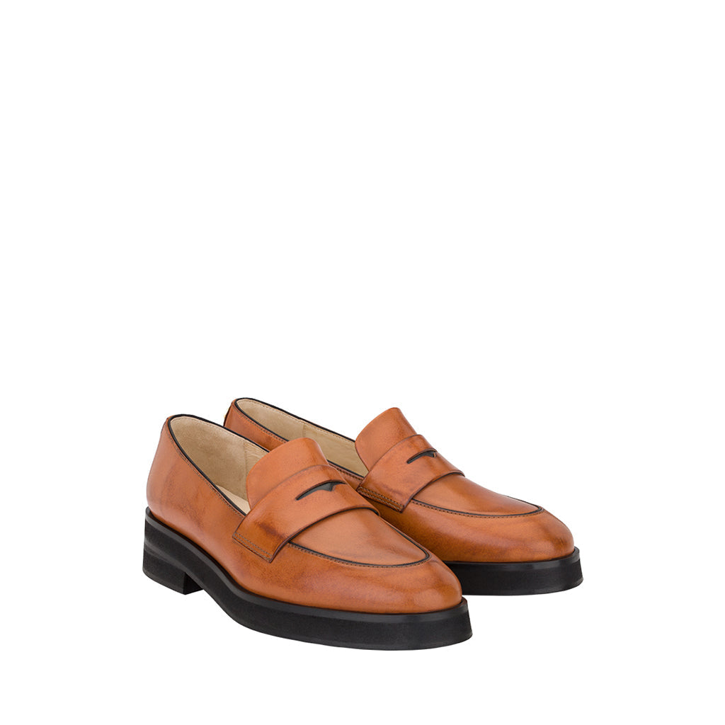 Tan leather loafers with black soles