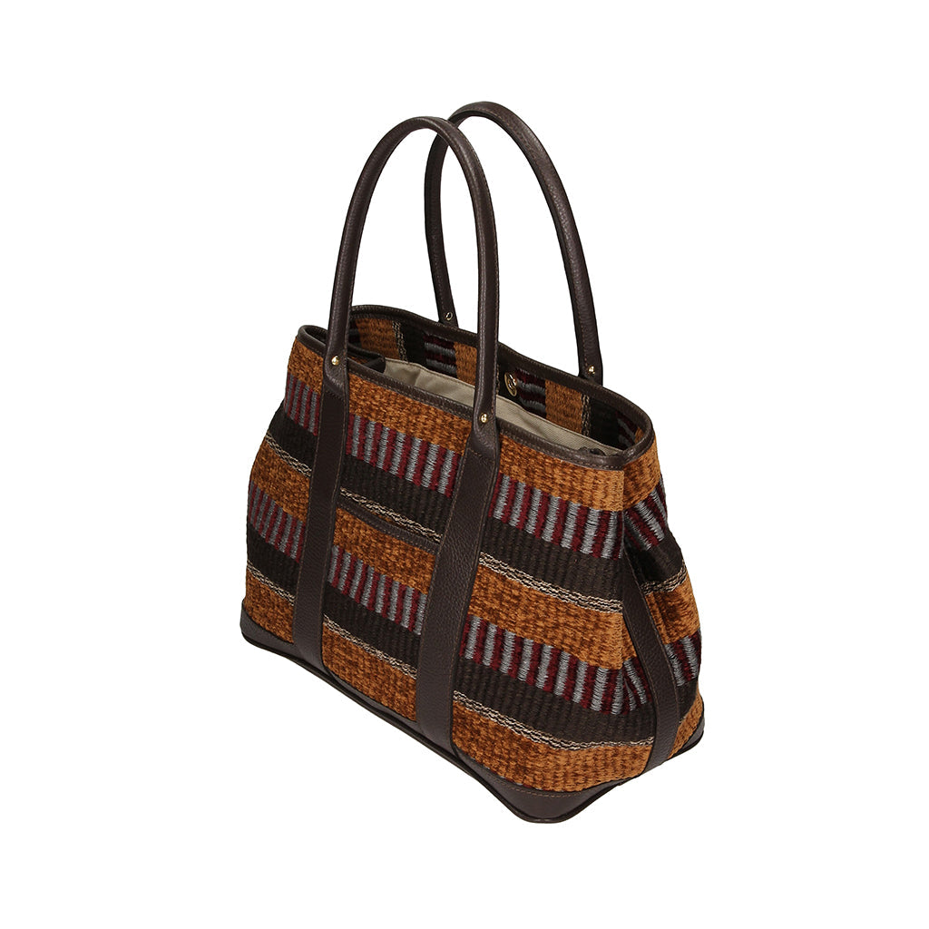 Handwoven striped tote bag with leather handles and spacious interior