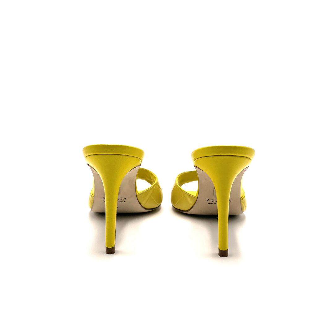 Yellow high-heeled open-toe shoes viewed from the back