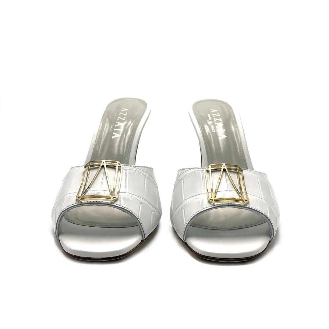 White open-toe slide sandals with gold buckle accents