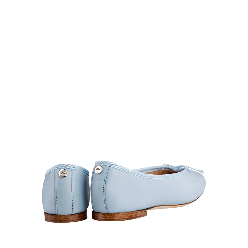 Light blue women's ballet flats with wooden soles, viewed from the back