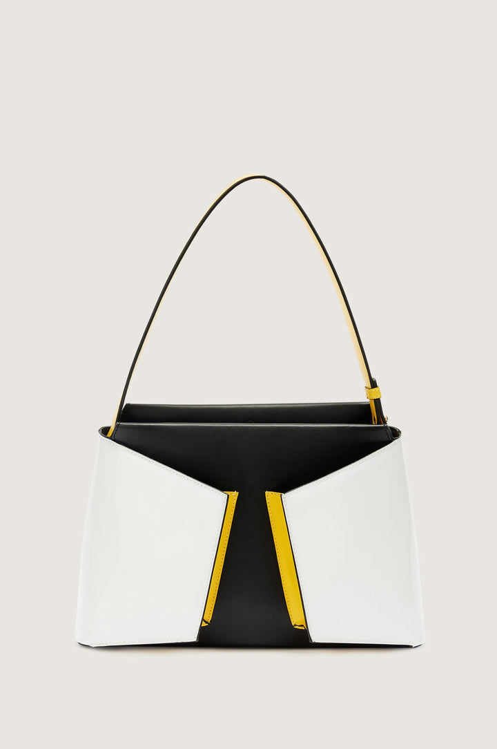 Black, white, and yellow designer handbag with unique geometric pattern