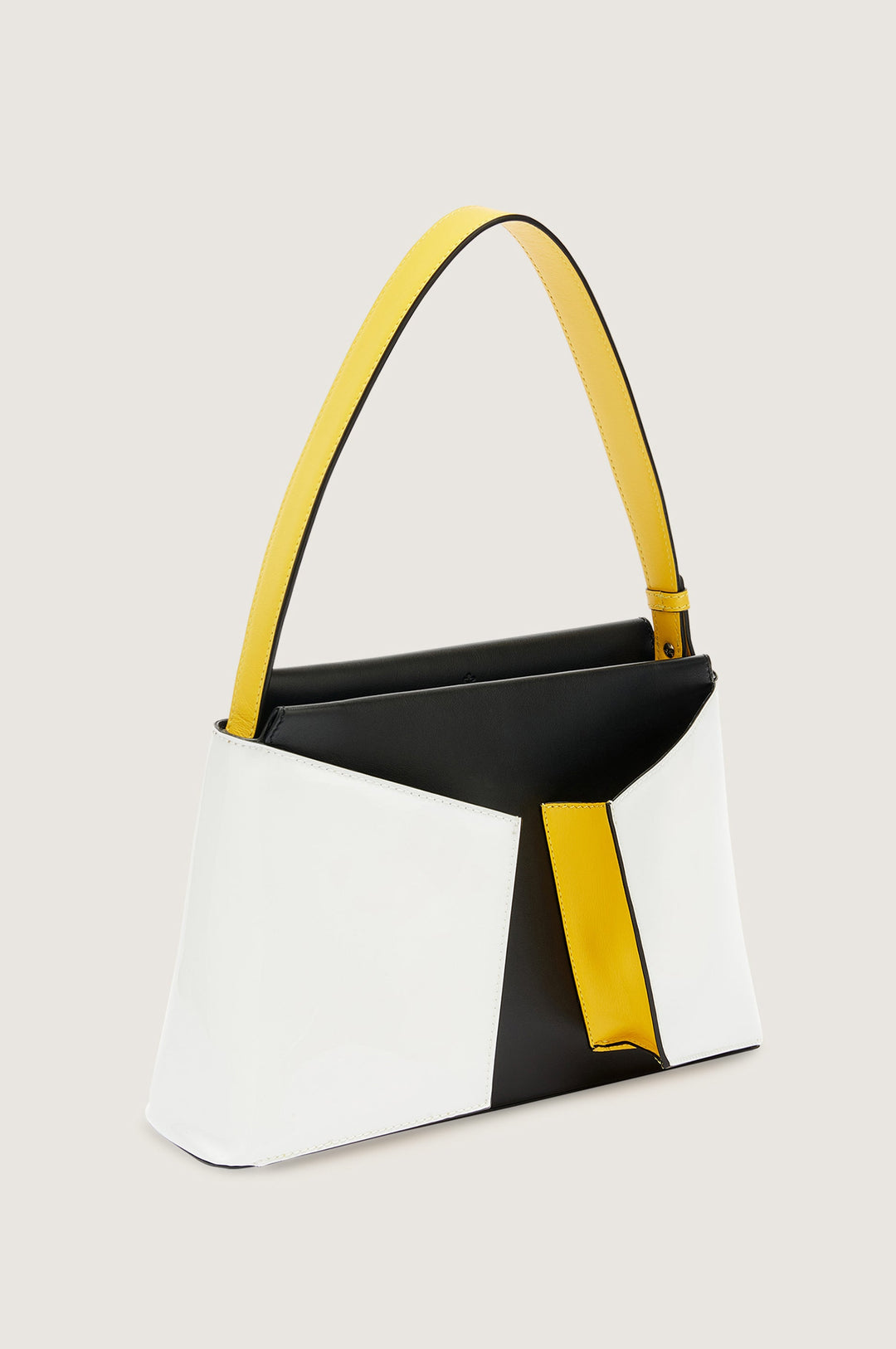 Stylish black, white, and yellow handbag with geometric design and single shoulder strap