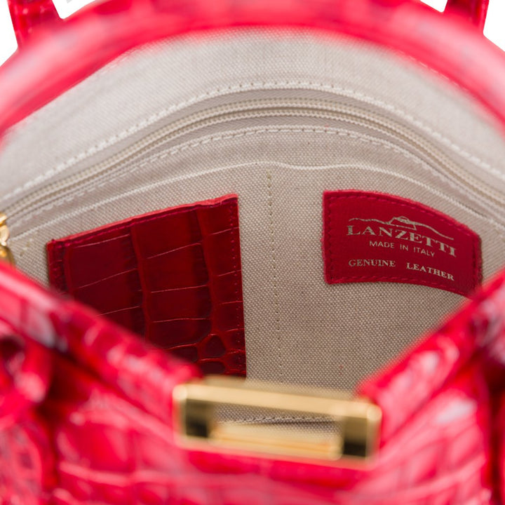 Interior view of a red Lanzetti genuine leather handbag with gold hardware, showing pockets and labels