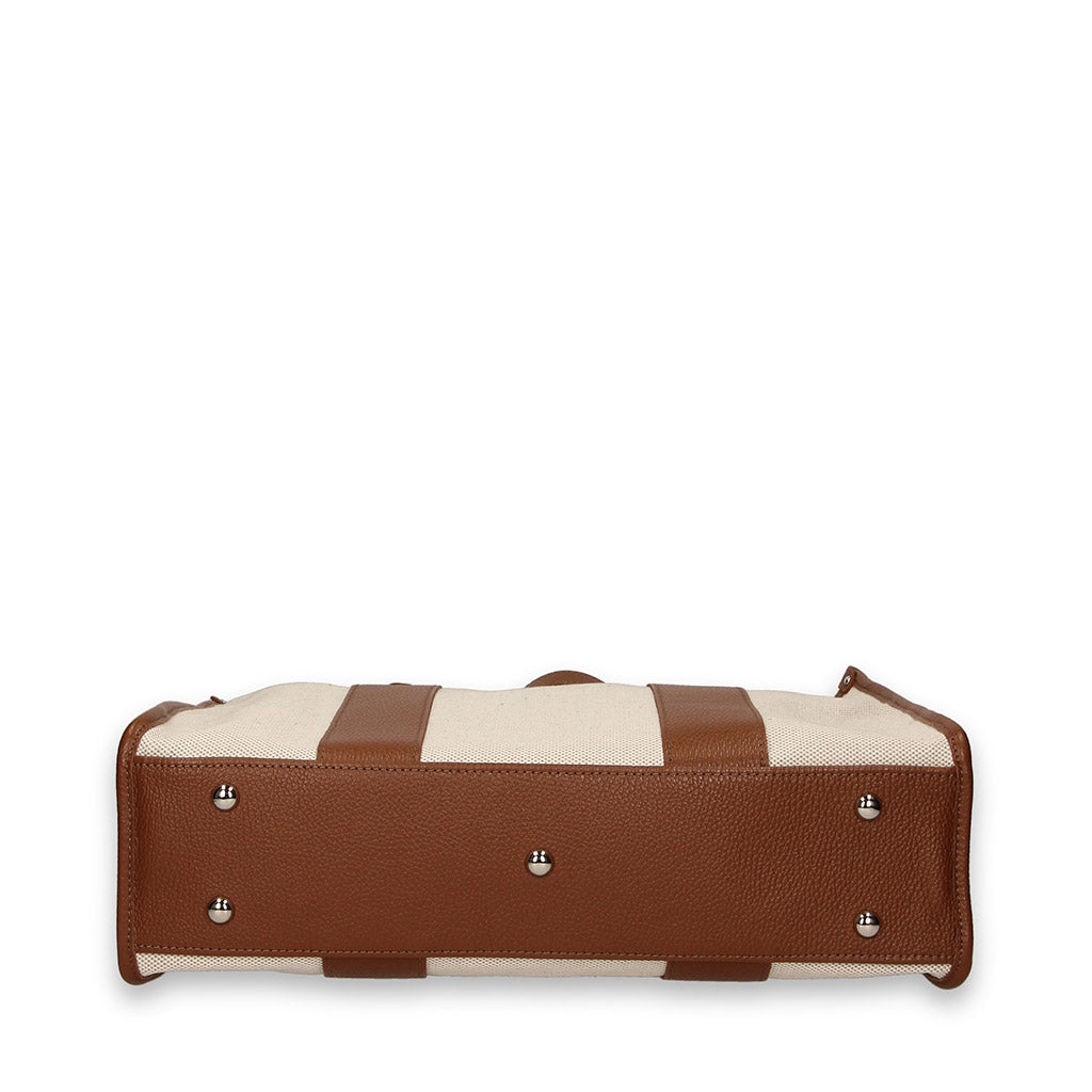 Bottom view of a beige and brown leather handbag with metal feet