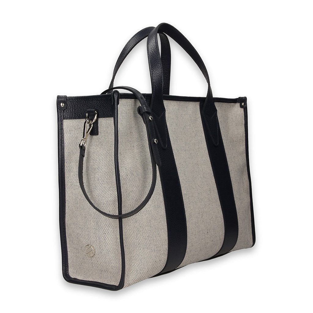 Elegant tote bag with black leather handles and beige fabric body