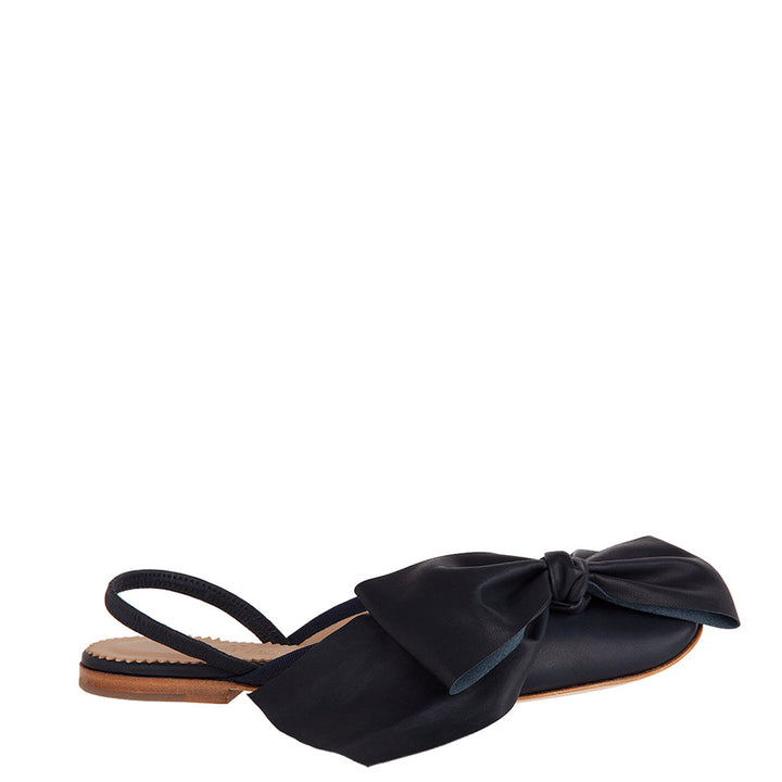 Black flat shoe with large bow and open heel strap