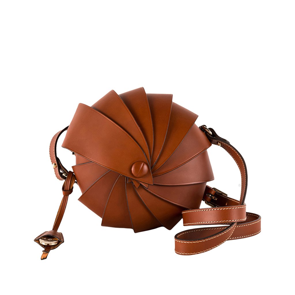 Unique brown leather spiral handbag with adjustable strap and detailed stitching