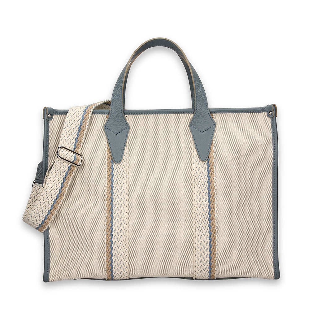 Cream and blue canvas tote bag with adjustable shoulder strap and leather accents