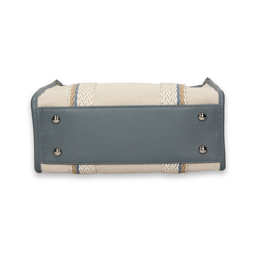 Bottom view of a stylish handbag showing metal studs and textured leather detailing