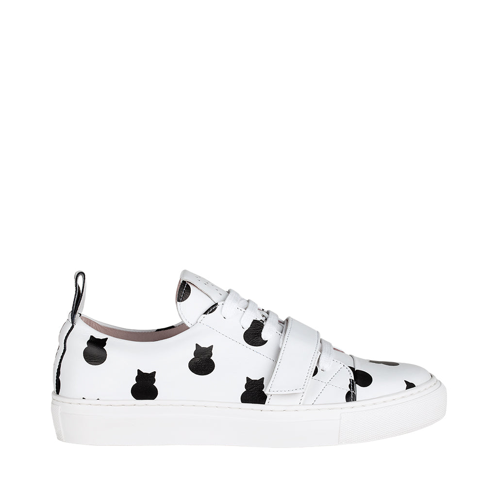 White sneaker with black cat pattern and white sole
