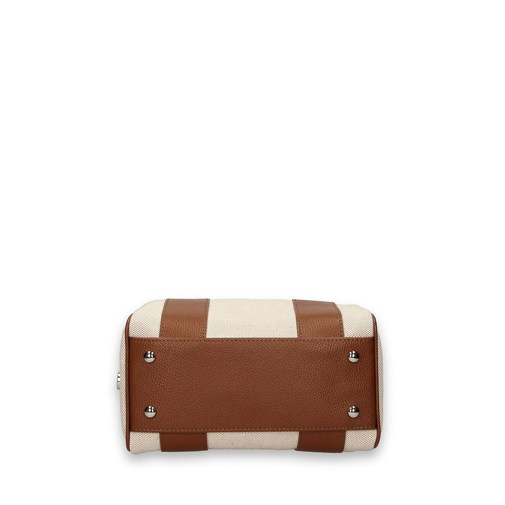 Tan and cream stylish handbag with metal studs on bottom view