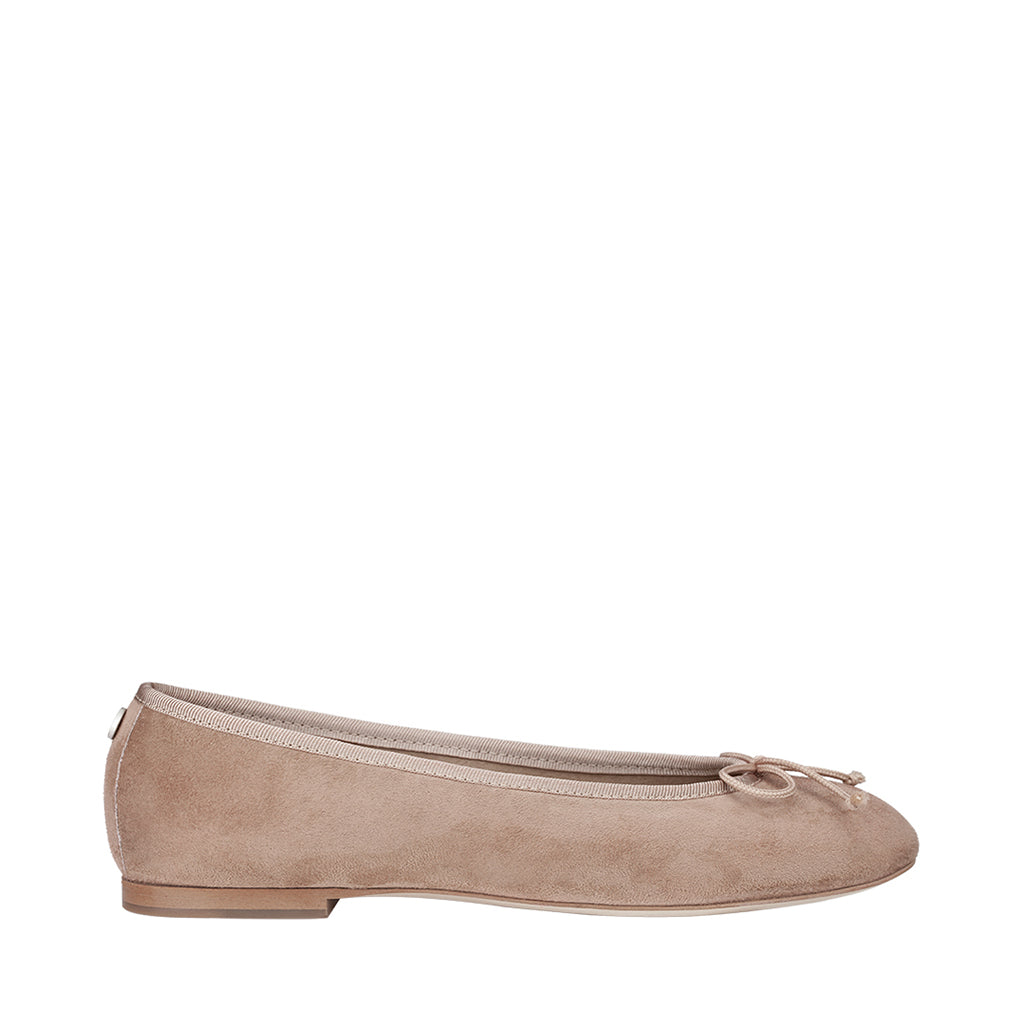 Beige ballet flat shoe with bow detail on a white background