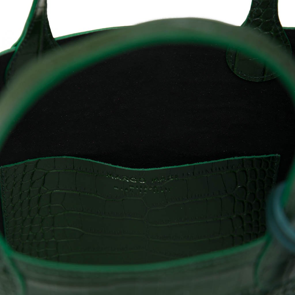 Green leather handbag with a black interior and crocodile texture