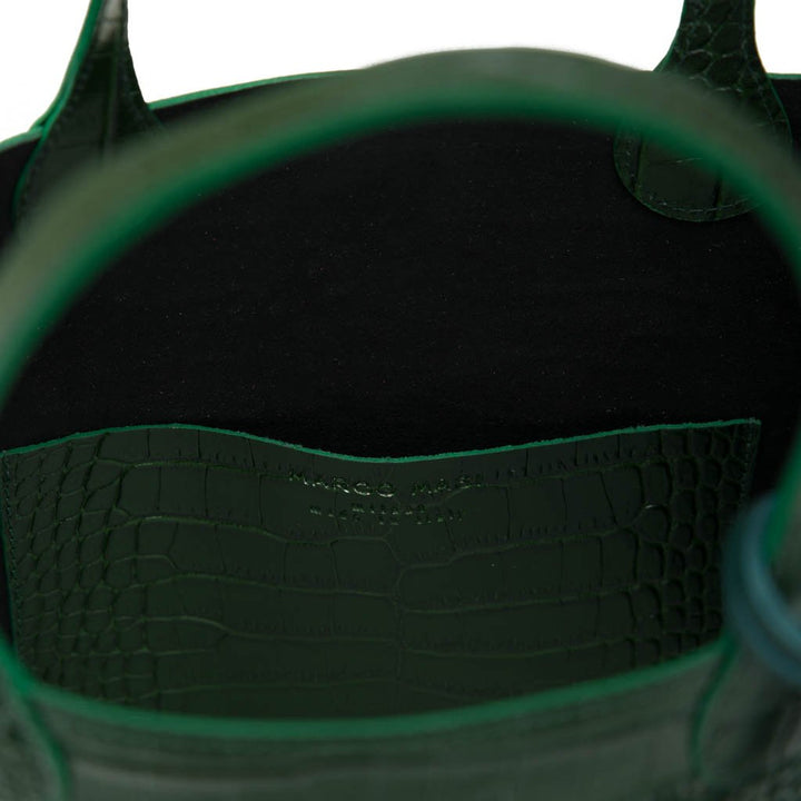 Green leather handbag with a black interior and crocodile texture