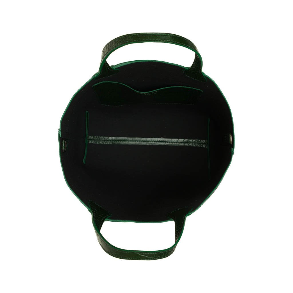 Top view of an empty green leather handbag with black interior and zipper pocket