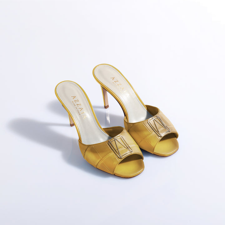 Yellow high-heeled sandals with open toes and buckle detail