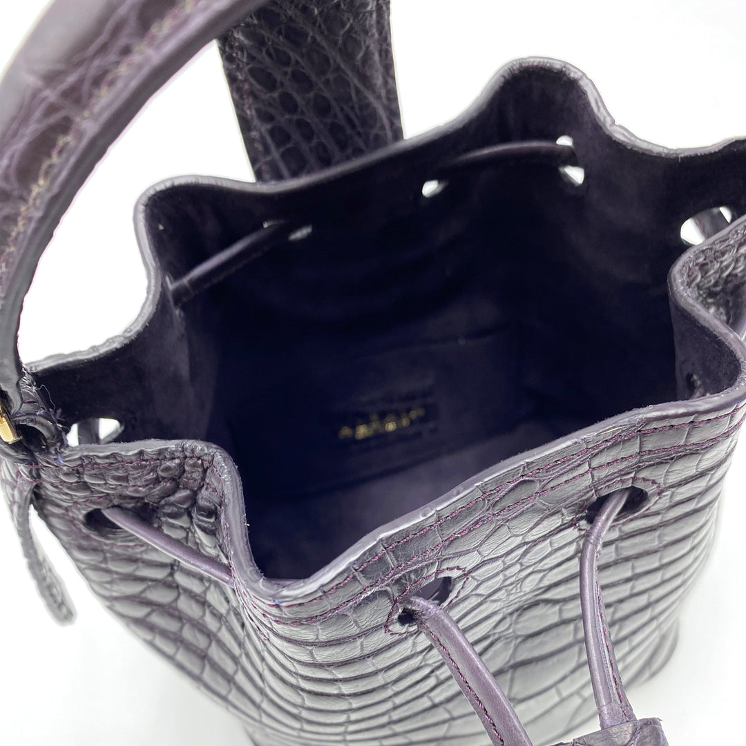 Close-up of a black leather crocodile pattern bucket handbag showing the interior