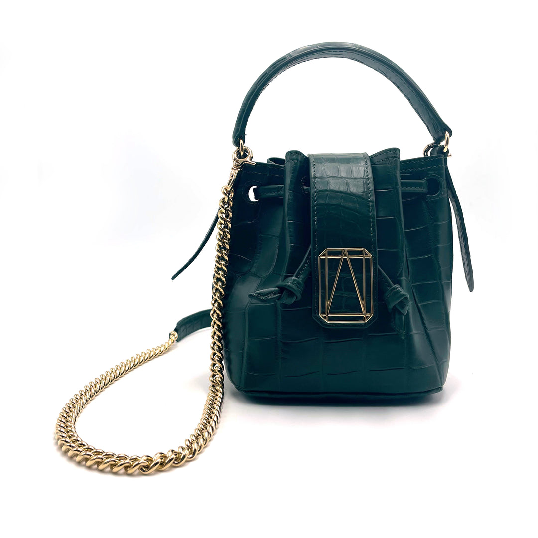 Green leather handbag with gold chain strap and decorative buckle against white background