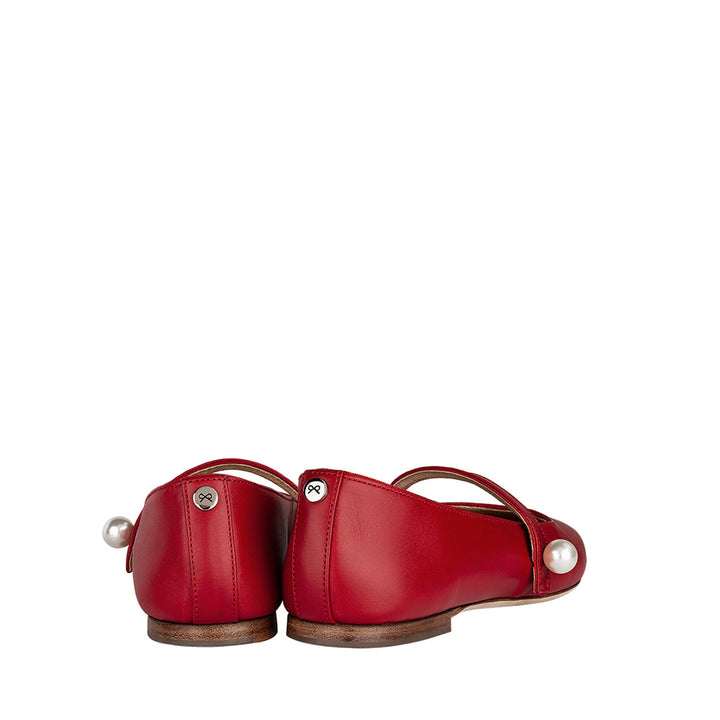 Red leather flat shoes with pearl detail, back view on white background
