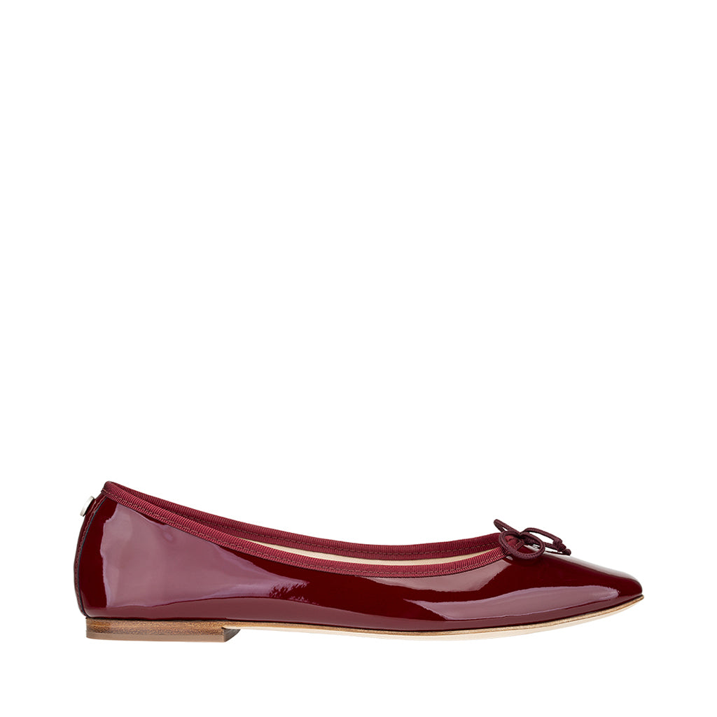 Red patent leather ballet flat with bow detail and low heel