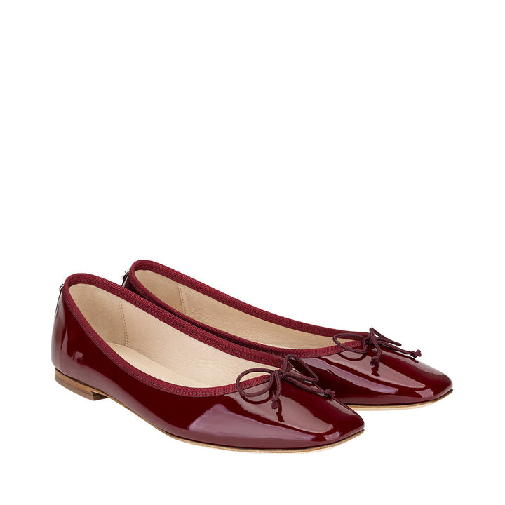 Shiny red patent leather ballet flats with bow detail