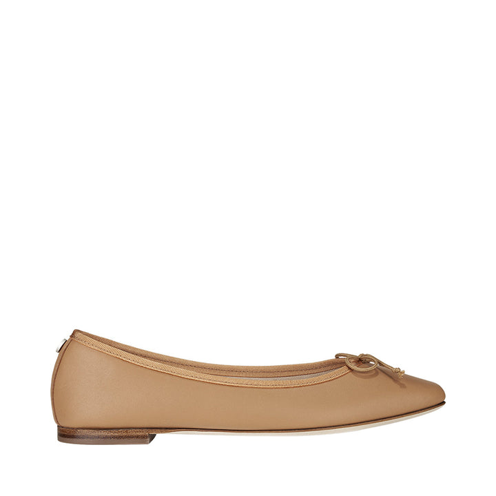 Beige ballet flat shoe with bow detail on white background